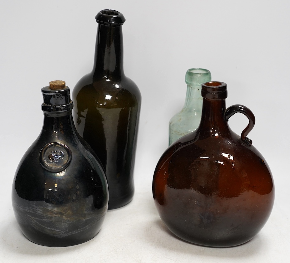 A Georgian wine bottle and three others including one bearing label reading ‘J.G. MONNET & Co. COGNAC’, tallest 27cm. Condition - commensurate with age